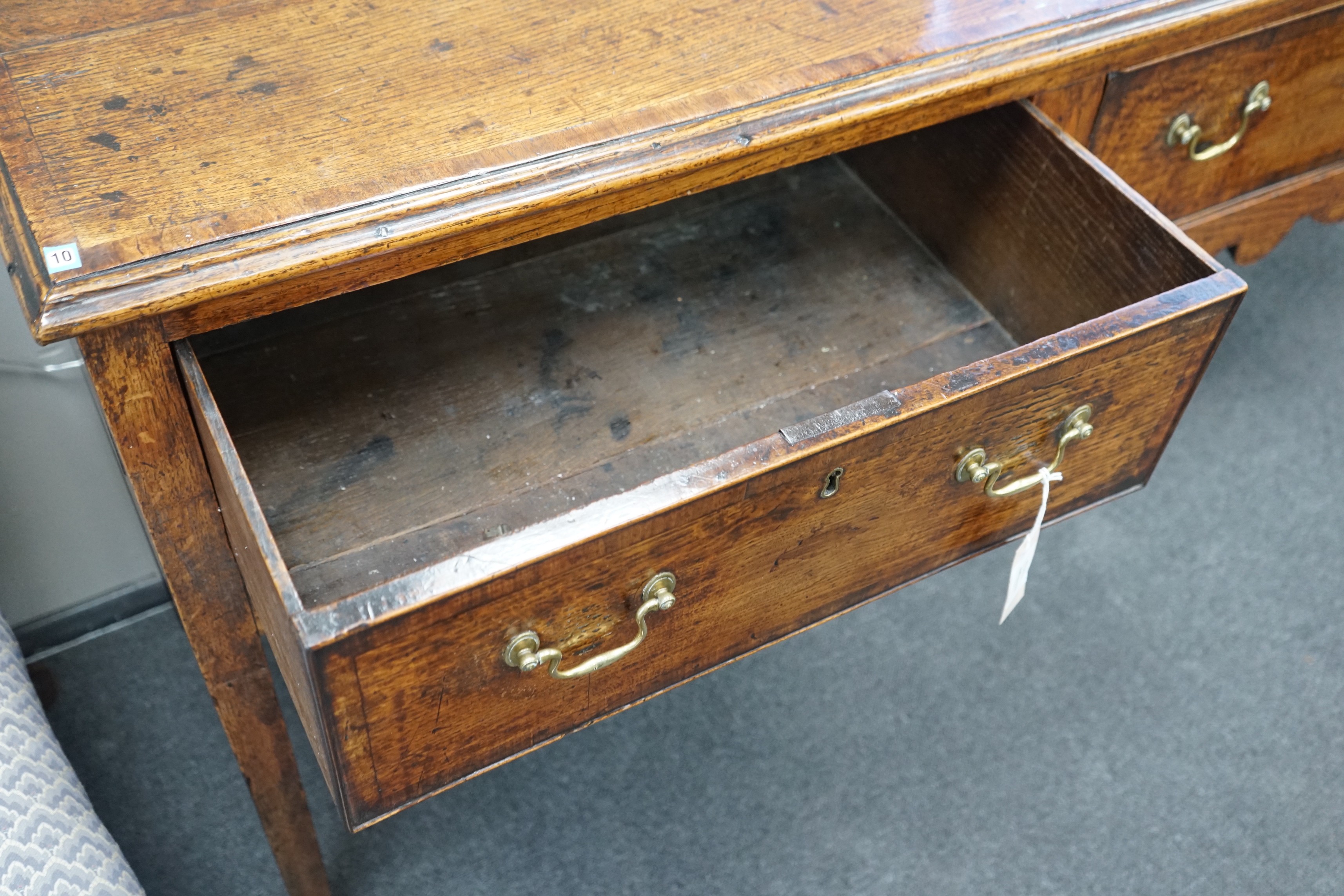 A George III provincial oak and mahogany banded low dresser with three drawers on square tapering legs, width 201cm, depth 46cm, height 83cm